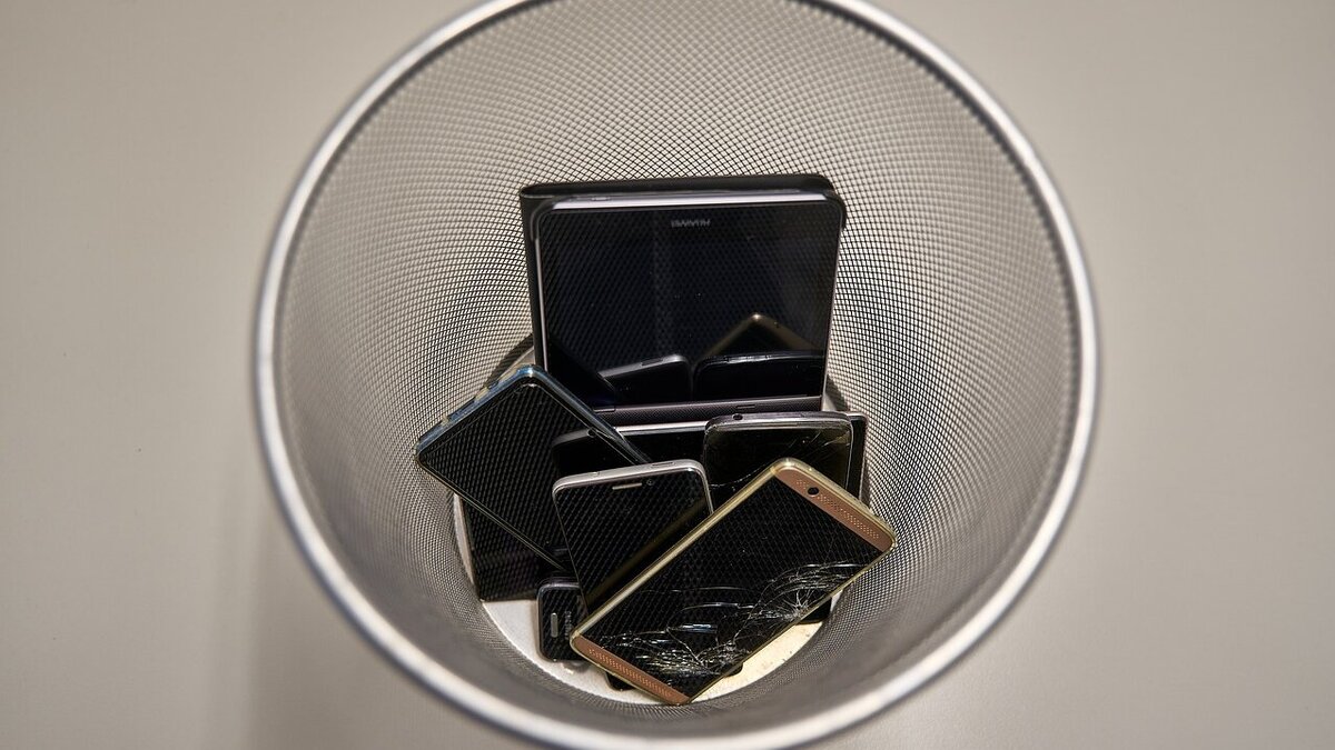 Das Bild zeigt einen Korb, in dem mehrere Handys gesammelt wurden.